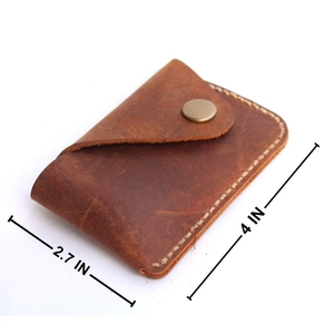 Detail view of handmade leather card holder with bronze snap button and 4x2.7 inch size