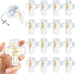 Macro detail of clear cross-shaped boxes with floral decals and white pearl rosary beads