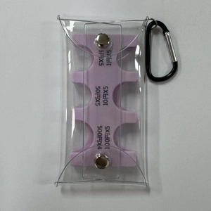 Flat lay of transparent PVC coin holder with internal purple sorting rack and carabiner