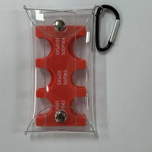 Detailed view of portable PVC coin organizer with Japanese yen slots and metal carabiner