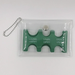 Macro detail of clear PVC coin pouch with green portable Japanese coin sorting holder