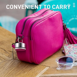 Mini aluminum alloy jewelry box with keychain hanging on a stylish pink leather handbag