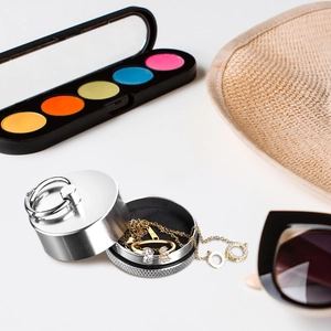 Close-up of portable silver mini jewelry box with ring and necklace in travel scene