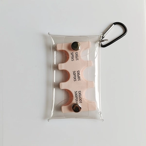 Detail of pink Japanese coin organizer with clear PVC case and black carabiner clip
