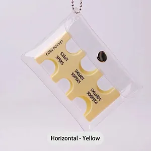 Detail of yellow Japanese coin organizer in clear PVC pouch with silver metal clasp