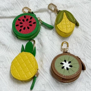 Detail of fruit-themed PU leather coin purses with litchi texture and gold metal clasps