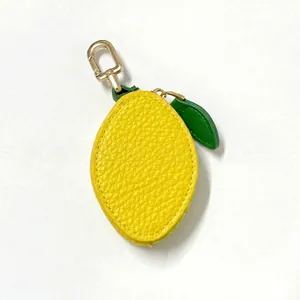 Detailed view of yellow lemon-shaped PU leather coin purse with green leaf and golden hook