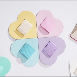 Macro shot of heart-shaped PU leather pen holders in various pastel colors for notebooks