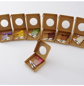 Detailed set of mini precision scissors with leather cases and tassels in seven colors