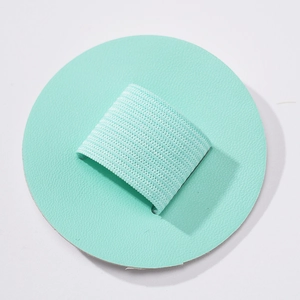 Macro detail of round mint green PU leather pen holder with elastic loop for notebooks