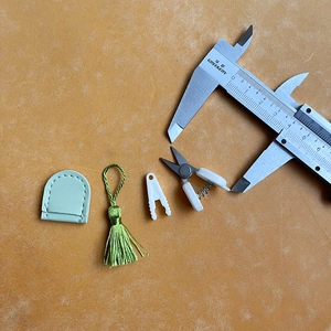 Macro view of mini high precision art scissors with size measurement and protective pouch