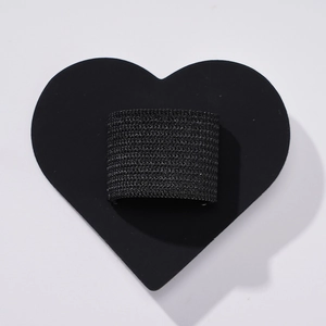 Detail of black elastic pen holder loop with adhesive heart-shaped PU leather base