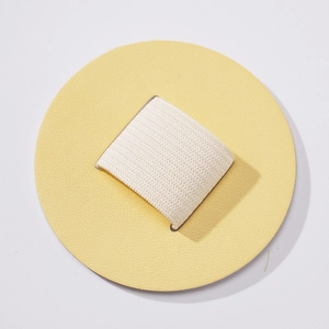 Detail view of round PU leather self-adhesive pen holder with white elastic loop strap
