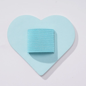 Close-up of light blue heart-shaped leather pen holder with elastic band for notebooks