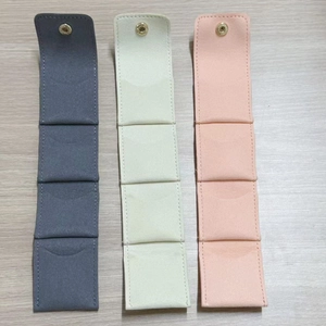 Macro detail of microfiber jewelry storage rolls with four slots and golden snap buttons