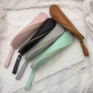 Minimalist PU leather pencil cases in five colors with rulers for scale comparison