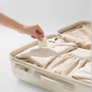 Portable beige leather jewelry storage box with gold snap button for travel organization