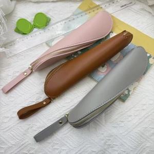Minimalist PU leather pencil cases in pink, brown and grey colors with zipper and hand strap