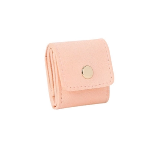 Macro detail of pink velvet jewelry pouch featuring a luxury gold metallic snap button
