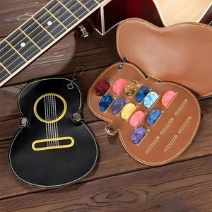 Guitar shaped leather pick holder set with colorful plectrums on rustic wood background