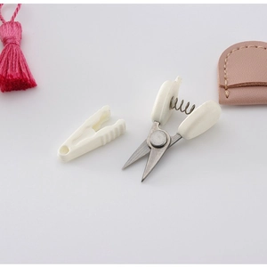 Mini high precision scissors with white handle and protective cap for sewing and craft