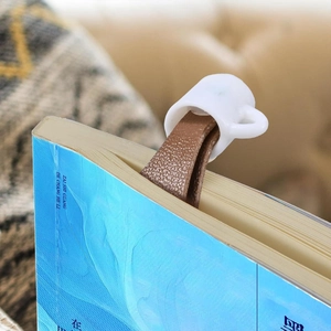 Creative spilled coffee cup bookmark with brown leather cord for unique reading experience