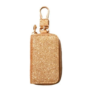 Detail of glittery gold leather car key holder case with a metallic zipper and swivel hook