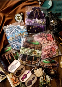 Detail of vintage junk journal material kit with velvet bag and astrology theme papers