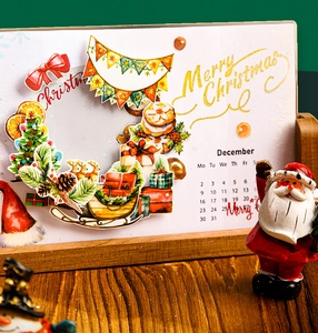 Macro detail of 3D Christmas calendar with reindeer, tree and sleigh on wooden base