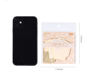 Detail view of 30pcs vintage scrapbook paper set with embossed patterns and phone for scale