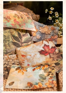 Detailed view of vintage autumn leaf junk journal paper with musical notes and script
