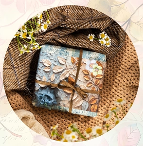 Detailed close-up of vintage floral embossed junk journal paper with autumn leaf patterns