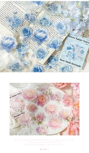 Detail of vintage PET floral stickers with watercolor roses on old book pages and porcelain