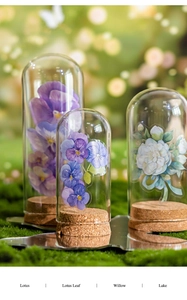 Close-up of decorative glass bell jar with cork base and floral PET stickers inside