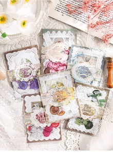 Detailed flat lay of vintage DIY junk journal kit with lace stickers and ribbons