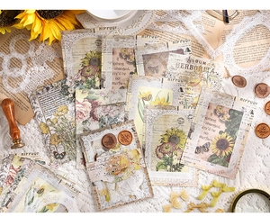 Close-up of vintage DIY lace stickers with sunflowers and retro newspaper patterns