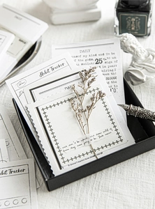 Macro view of vintage style habit tracker and daily cards set with retro stationery props