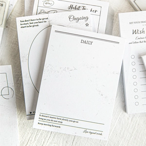 Vintage minimalist notepad set with daily planners and habit trackers on linen texture
