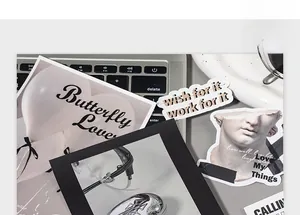 Artistic stationery set with butterfly cards and aesthetic stickers on laptop keyboard
