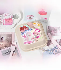 Detail of pink Korean stationery stickers with rabbits and cakes on a lunch box