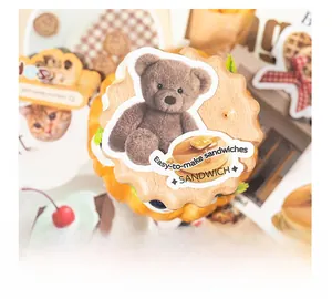 Close-up of decorative bear and pancake wooden craft tags for DIY scrapbooking