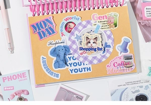 Macro detail of Korean style planner stickers showing cute animals and retro icons