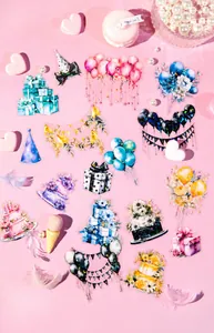Flat lay of watercolor festival stickers with cake and balloons on pink background