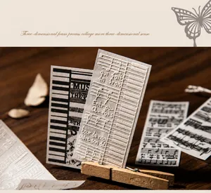Close-up of 3D foam texture on vintage music stickers with piano keys and notes