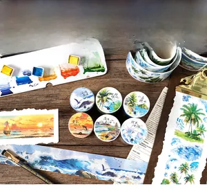 Detailed view of watercolor ocean scenery washi tape set on a vintage wooden desk