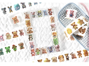 Detailed view of animal washi tape rolls and stickers with plush texture on quilted fabric