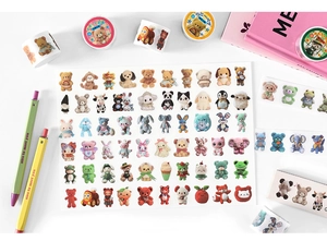 Detailed flat lay of cartoon animal washi tapes and stickers for DIY journals