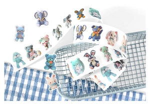 Close-up of decorative washi tape with cute animal doll illustrations and pastel patterns