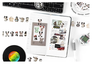 Flat lay of cute animal washi tape rolls and stickers decorating a minimalist desk scene