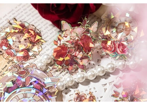 Nahaufnahme der PET-Sticker mit holografischen Rosen- und Uhrenmotiven und Laser-Effekt